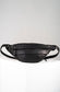 Black leather waist bag on a light gray background